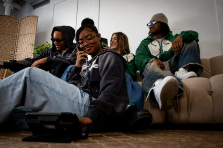 people sitting wearing enjoy life hoodies