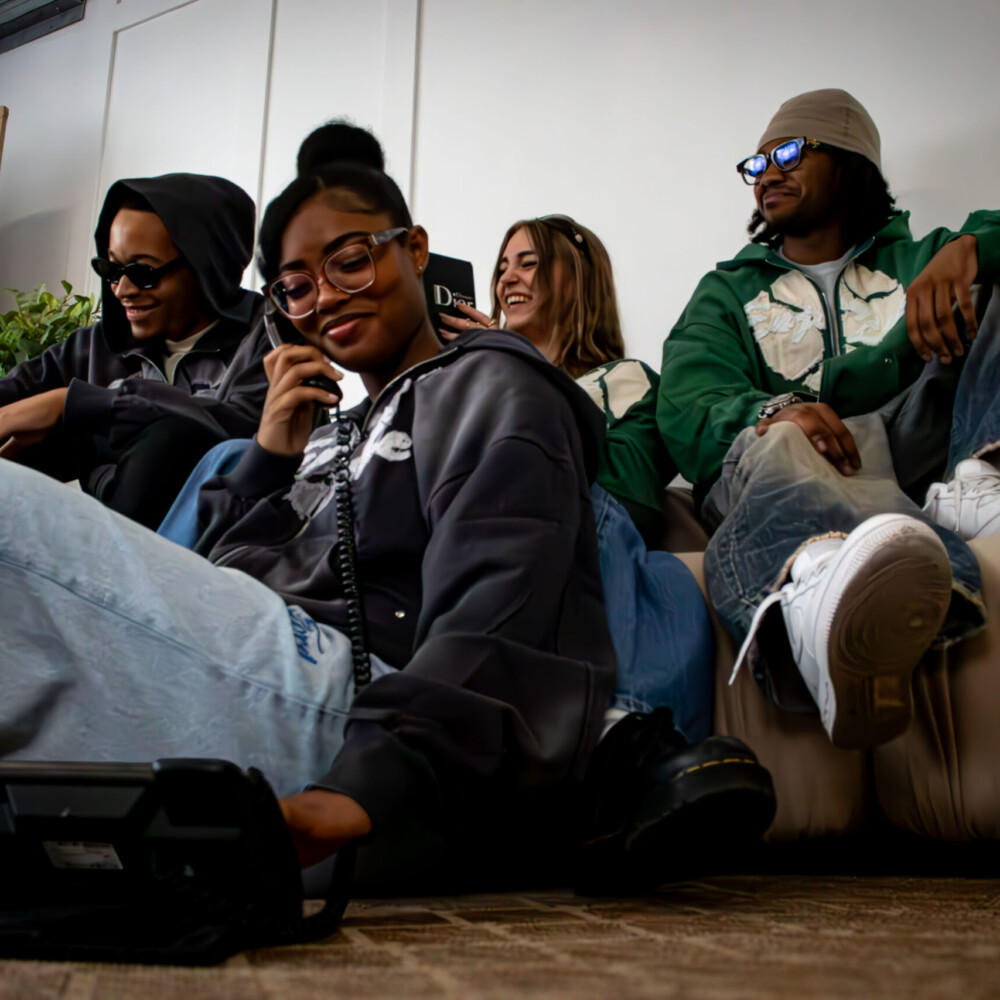 people sitting wearing enjoy life hoodies